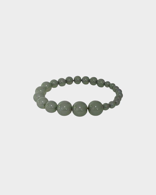 A beaded stretch bracelet made of smooth, polished round beads in eucalyptus green color, danish design, made in copenhagen denmark by lemonade ltd