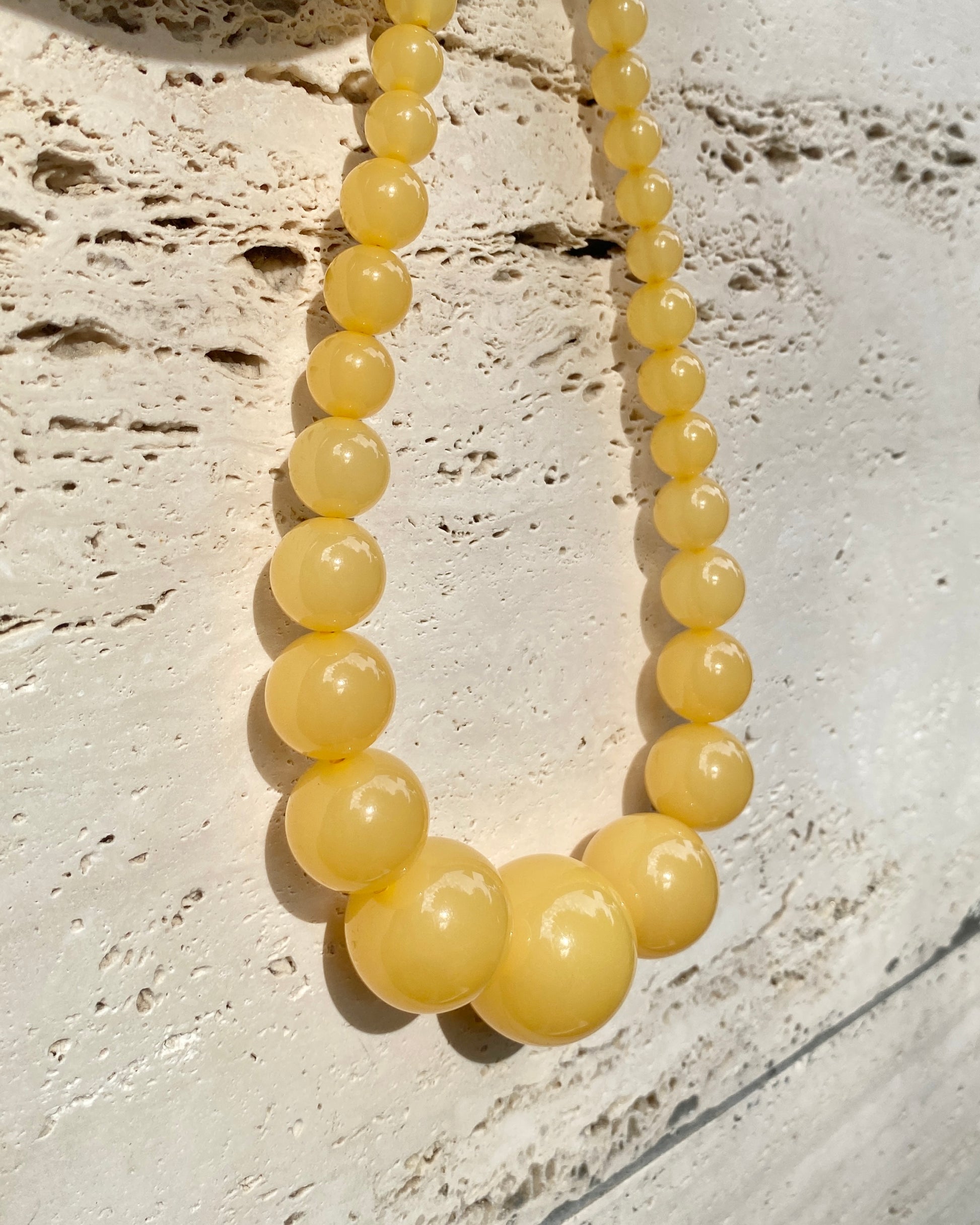 lemonade mega-necklace , honey on travetin background